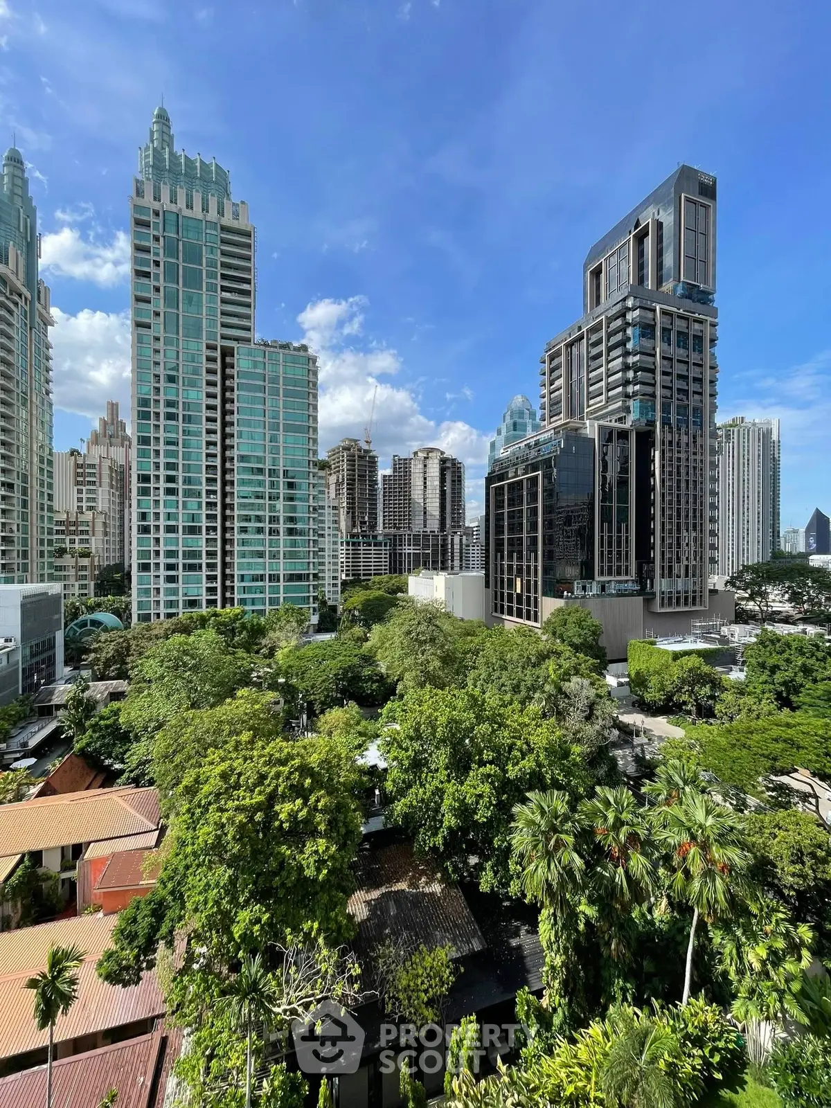 Stunning cityscape view with modern skyscrapers and lush greenery, perfect for urban living.