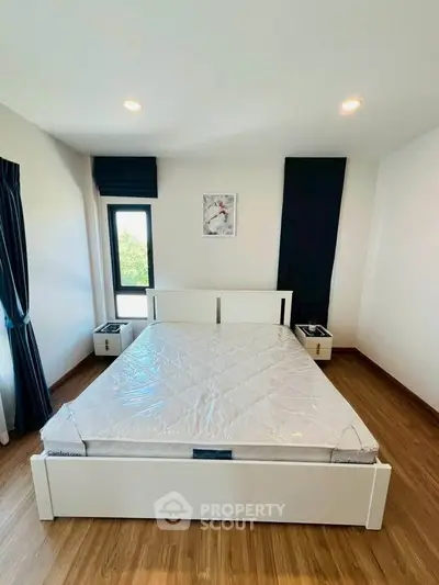 Modern bedroom with large window and stylish decor