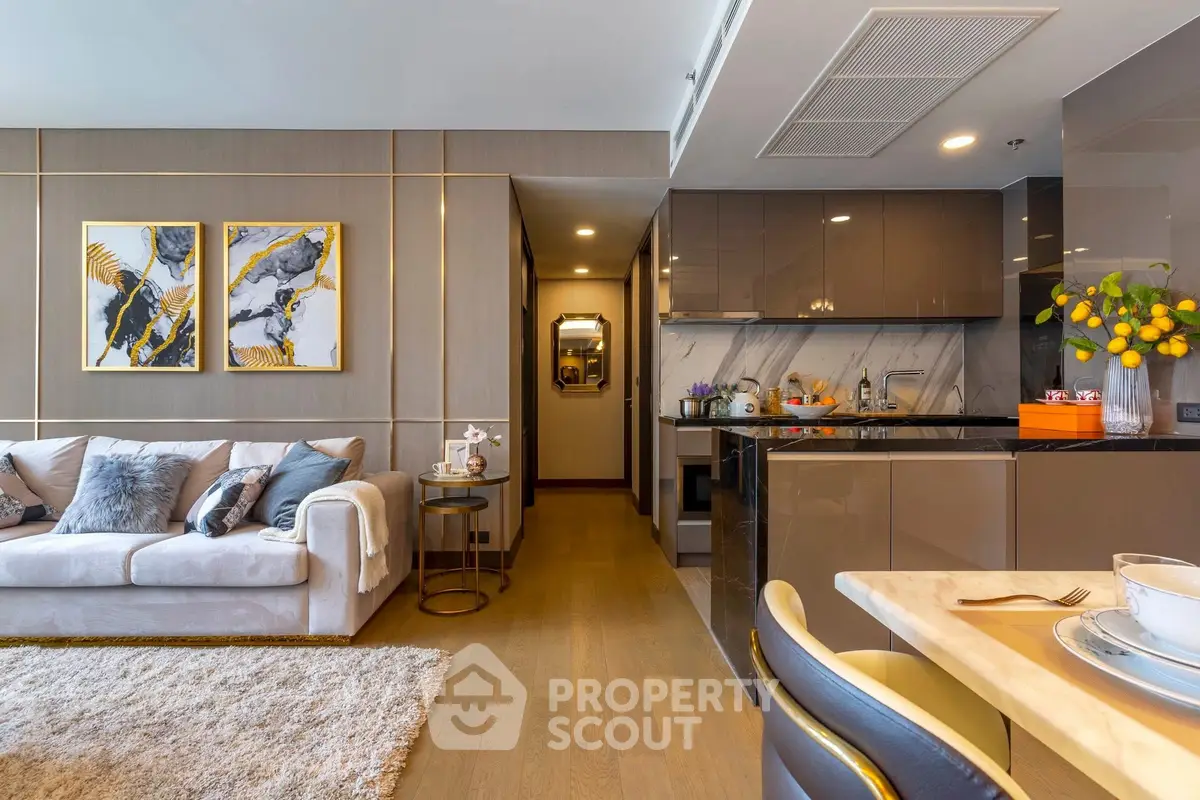 Modern open-layout living room with stylish decor and kitchen area.