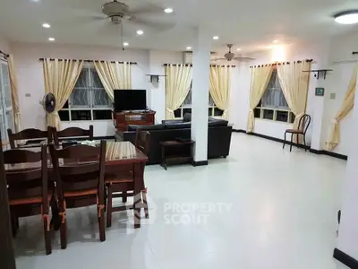 Spacious open-layout living room with elegant dining area and modern furnishings.
