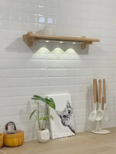Modern kitchen with stylish shelf and utensils on tiled wall