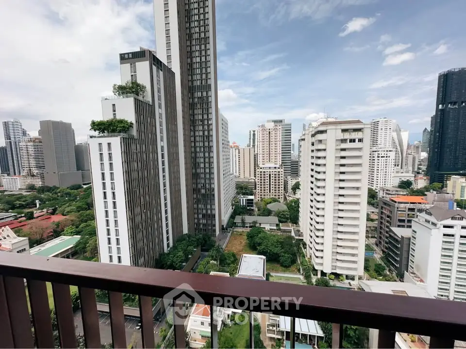 Stunning cityscape view from a high-rise balcony showcasing modern skyscrapers and lush greenery.