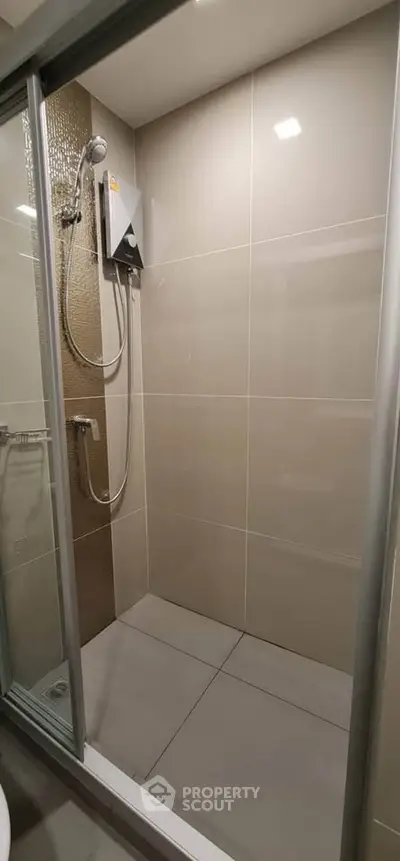 Modern bathroom with sleek shower design and neutral tiles