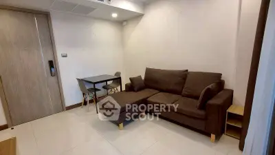 Modern living room with cozy brown sofa and dining area