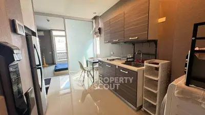 Modern kitchen with sleek cabinets and dining area in bright apartment