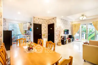 Spacious open-plan living and dining area with modern decor and garden view.