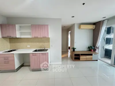 Modern open-layout kitchen with sleek cabinetry and spacious living area