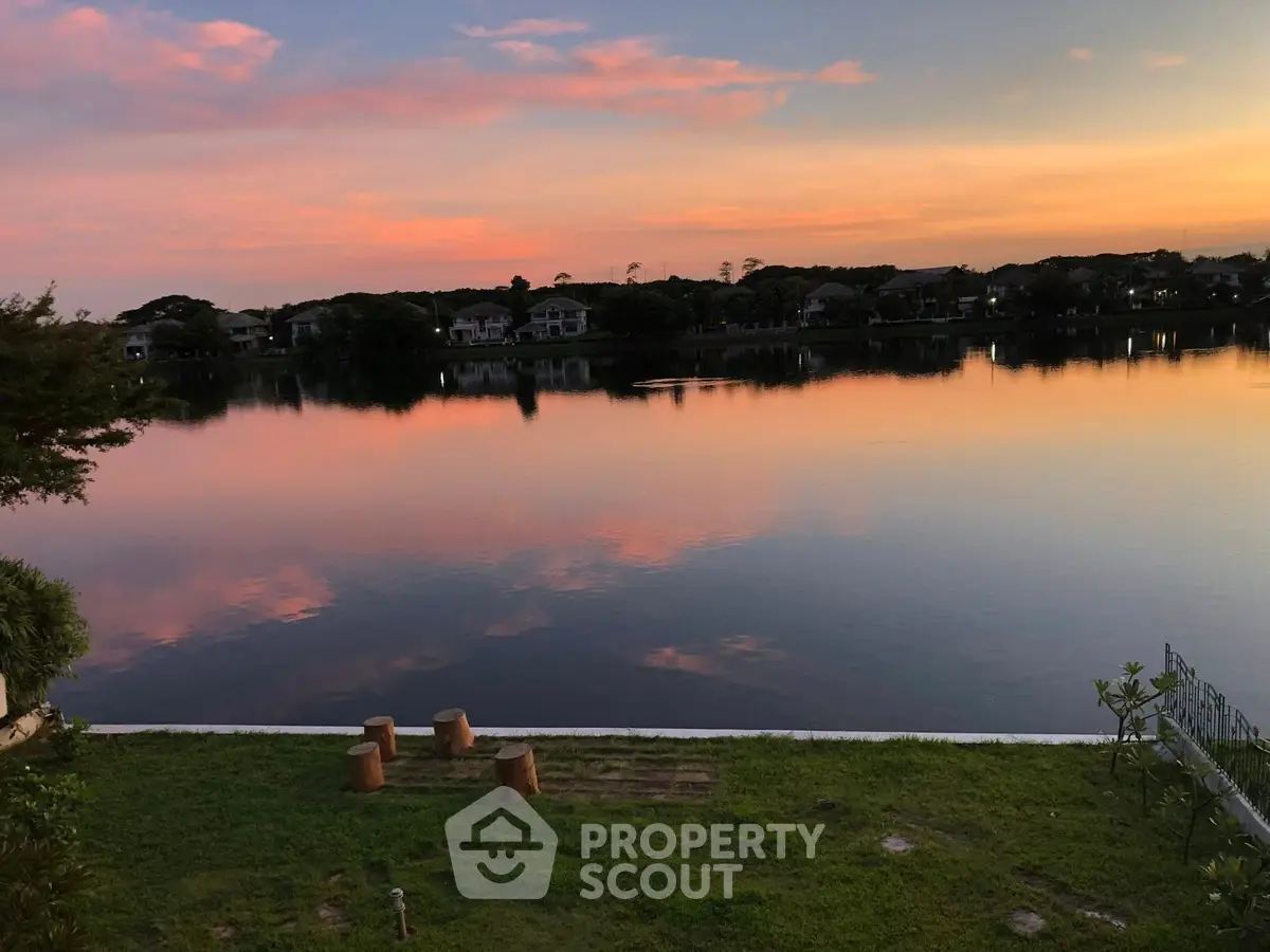 Stunning lakeside view at sunset with serene reflections and lush greenery.