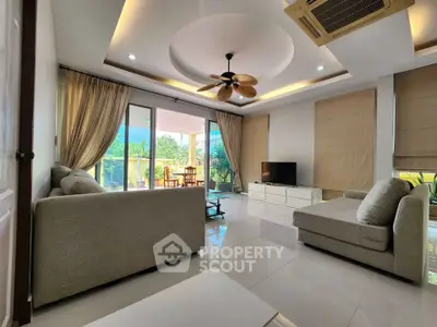 Luxurious living room with modern decor and large balcony view