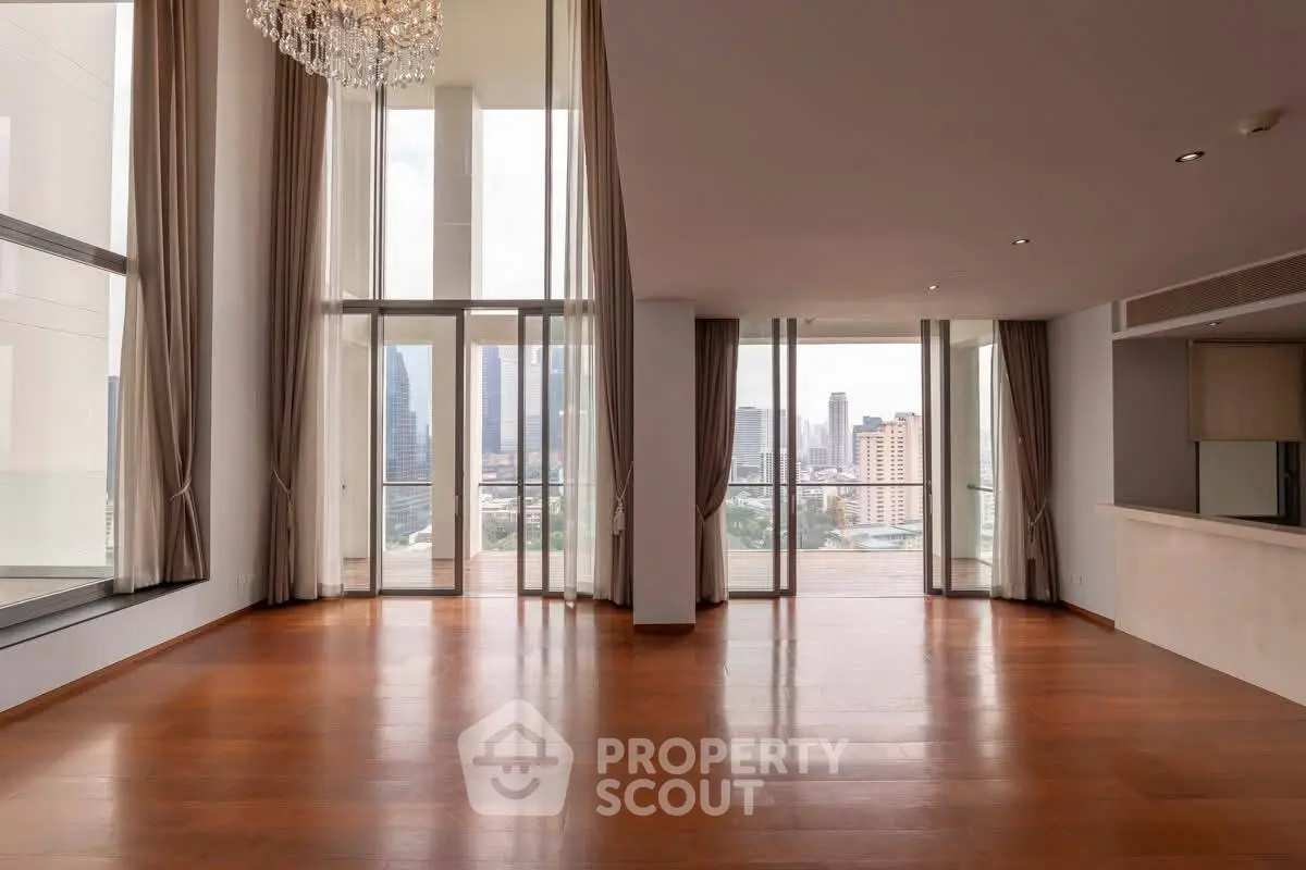 Spacious luxury living room with floor-to-ceiling windows and stunning city view