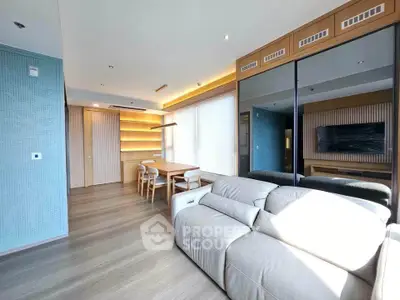 Modern living room with sleek design, large sofa, and stylish dining area in open layout.