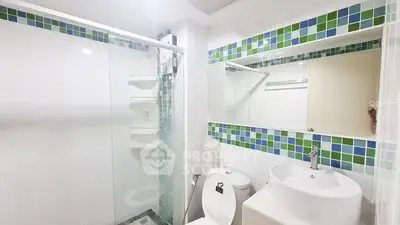 Modern bathroom with glass shower and colorful tile accents