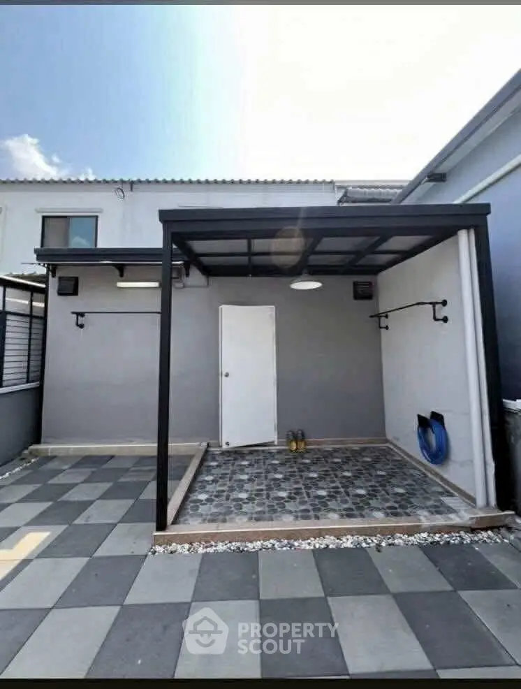 Modern exterior with covered patio and stylish tile flooring