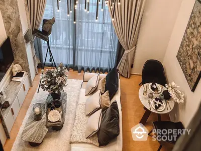 Cozy and inviting living room with plush seating, elegant decor, and access to a sunlit balcony, perfect for relaxation and entertaining guests.