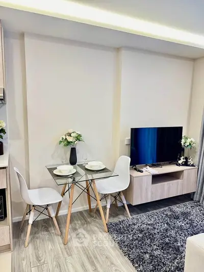 Modern living room with stylish dining area and sleek TV setup