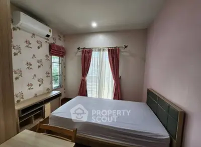 Cozy bedroom with floral wallpaper and natural light