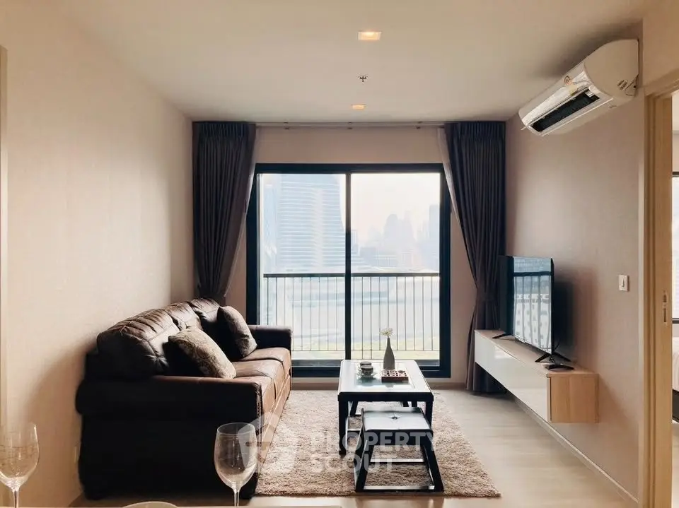 Modern living room with city view, featuring a cozy sofa and wall-mounted TV.