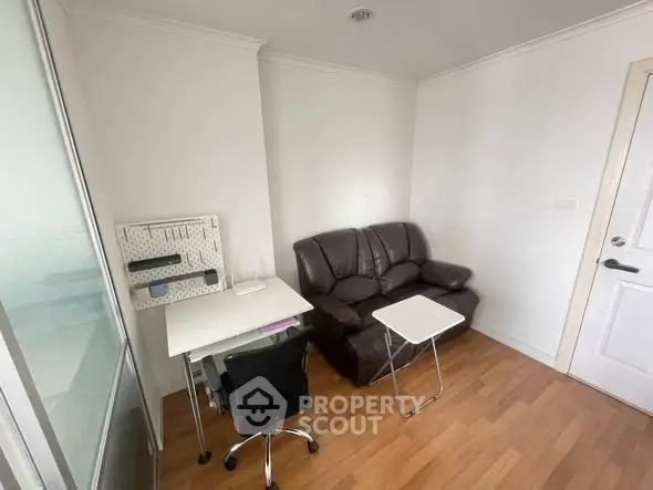 Cozy study room with leather sofa and modern desk in bright apartment
