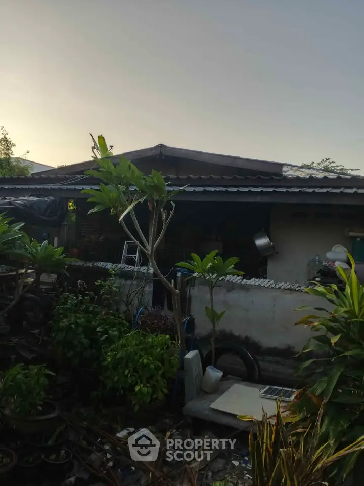 Charming single-story home with lush garden and rustic exterior.