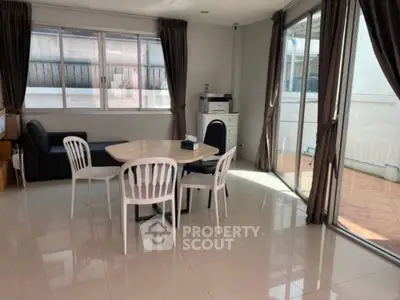 Spacious living room with large windows and modern furniture, perfect for entertaining.
