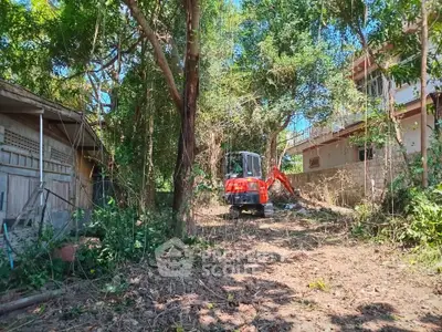 Spacious garden area with construction equipment, ideal for landscaping or development.
