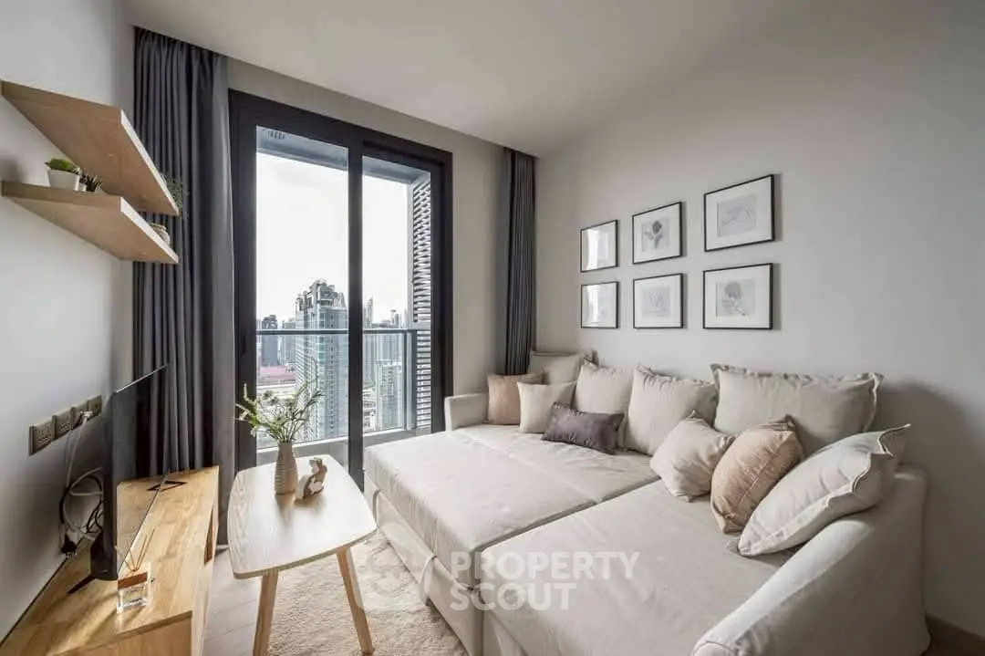 Modern living room with cozy sofa and city view balcony, perfect for urban living.