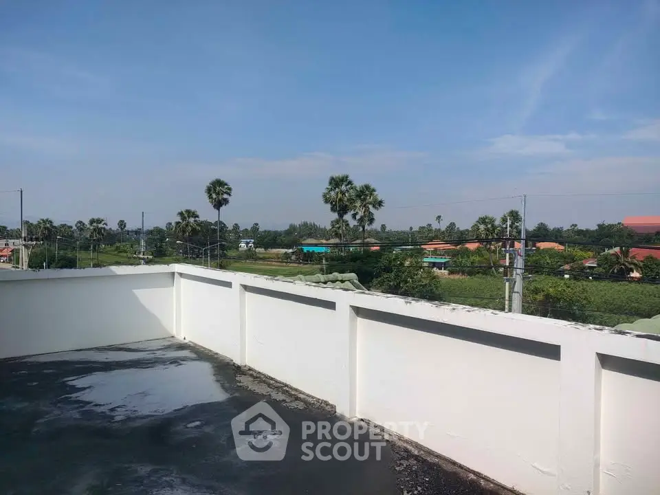 Stunning rooftop view with lush greenery and clear blue skies, perfect for relaxation and leisure.