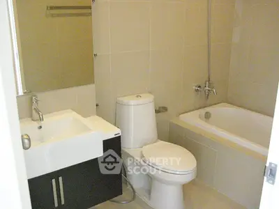 Modern bathroom with sleek fixtures and a bathtub in a contemporary apartment.