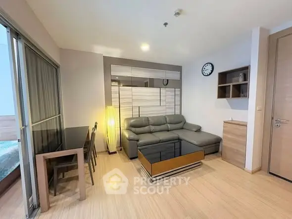Modern living room with stylish furniture and wooden flooring in a cozy apartment.