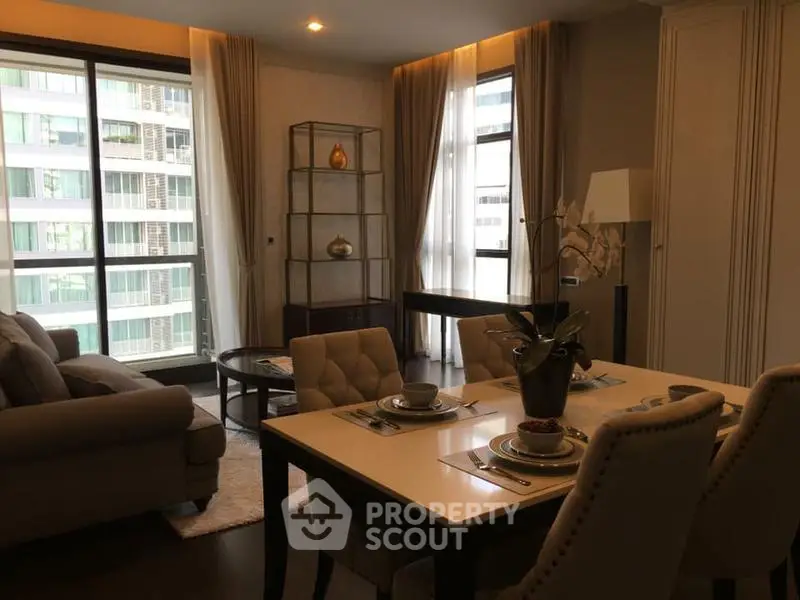 Elegant living room with modern furniture and large windows in a high-rise apartment.
