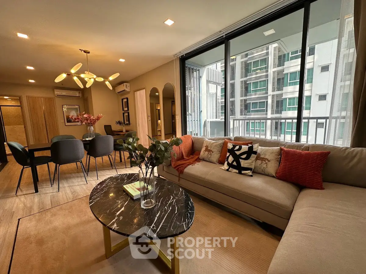 Modern living room with stylish decor and large windows in urban apartment