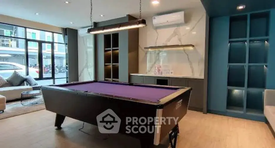 Stylish living room with pool table and modern decor, perfect for entertainment and relaxation.