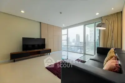 Spacious modern living room with city view and sleek furnishings