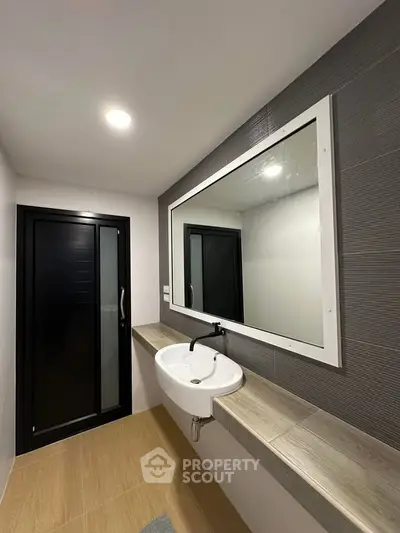 Modern bathroom with sleek design and large mirror