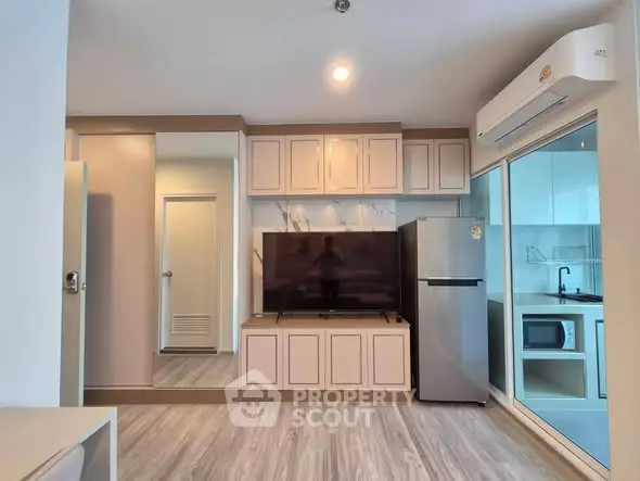 Modern living room with sleek design and integrated kitchen appliances