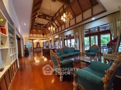 Luxurious living room with high wooden ceilings and elegant furnishings