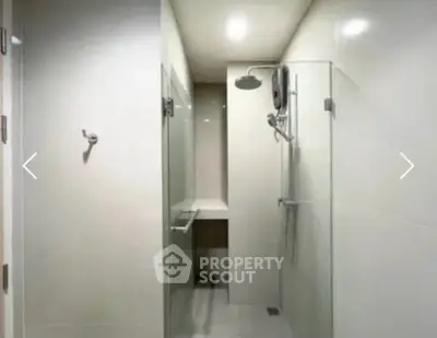 Modern bathroom with glass shower enclosure and sleek fixtures