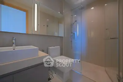 Modern bathroom with sleek fixtures and glass shower enclosure