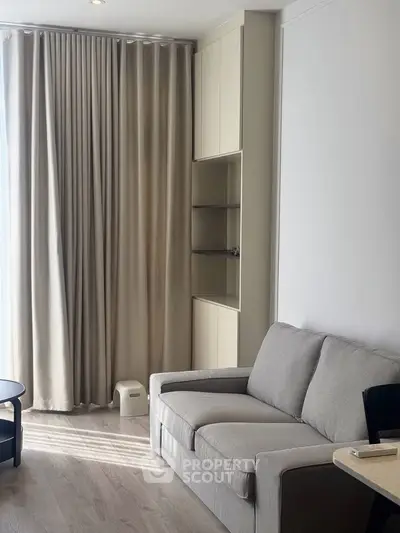 Modern living room with elegant beige curtains and cozy gray sofa
