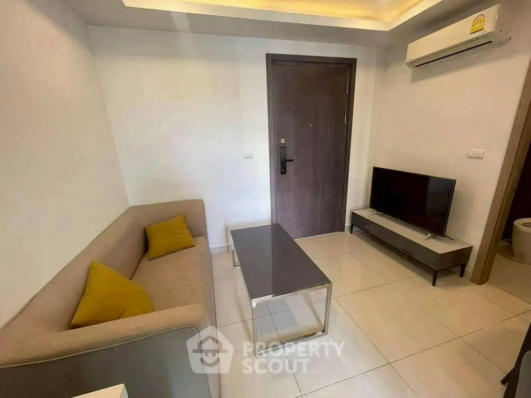 Modern living room with sleek furniture and air conditioning, perfect for cozy relaxation.