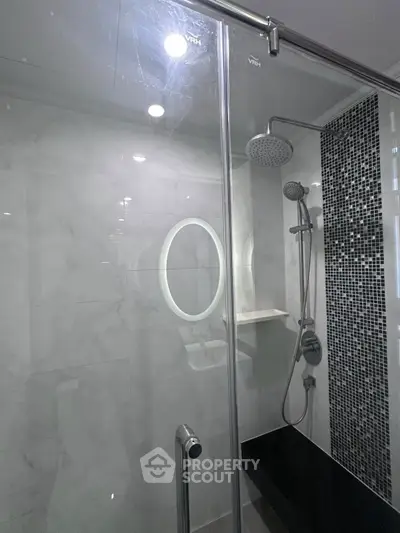 Modern bathroom with glass shower and stylish tile accents