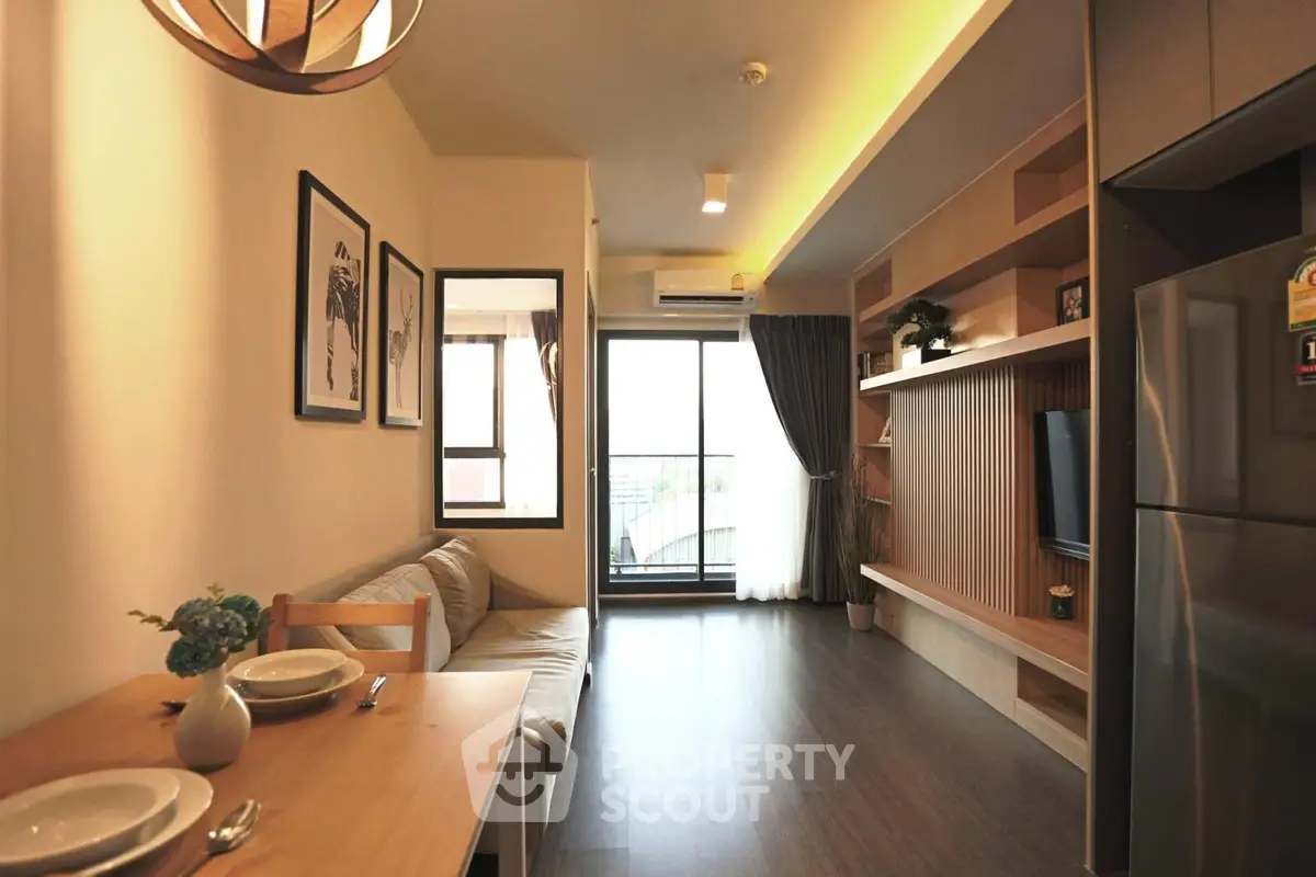 Modern living room with open layout, stylish decor, and balcony access in a contemporary apartment.