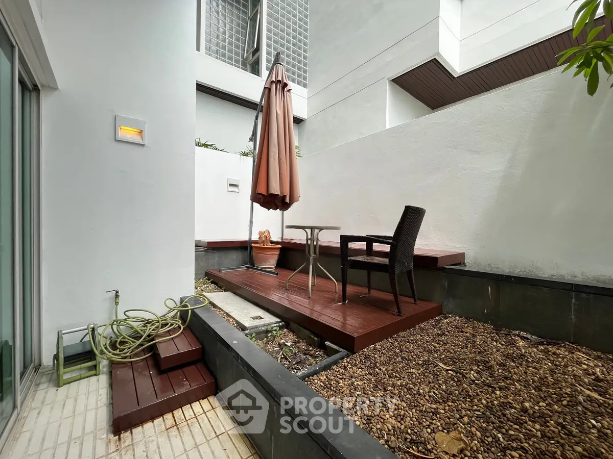 Charming outdoor patio with seating area in modern residential complex