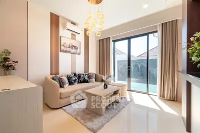 Luxurious living room with elegant decor and pool view, featuring modern furniture and stylish lighting.