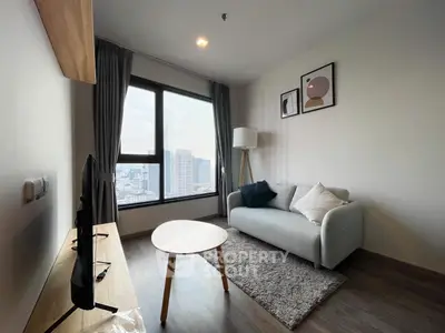 Modern living room with city view, stylish decor, and cozy seating area.