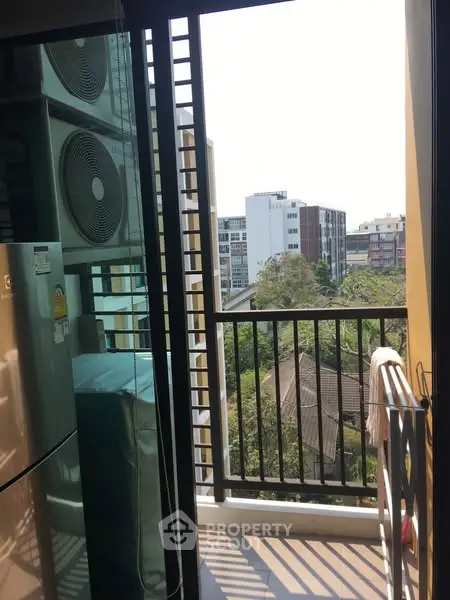 Charming balcony with city view and modern appliances, perfect for urban living.