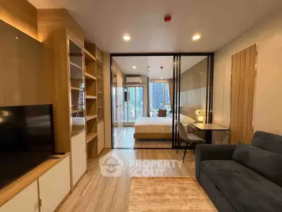 Modern studio apartment with glass partition, cozy living area, and city view.