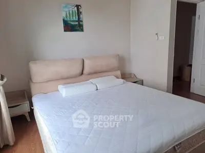 Cozy bedroom with a comfortable bed and minimalist decor, perfect for relaxation.