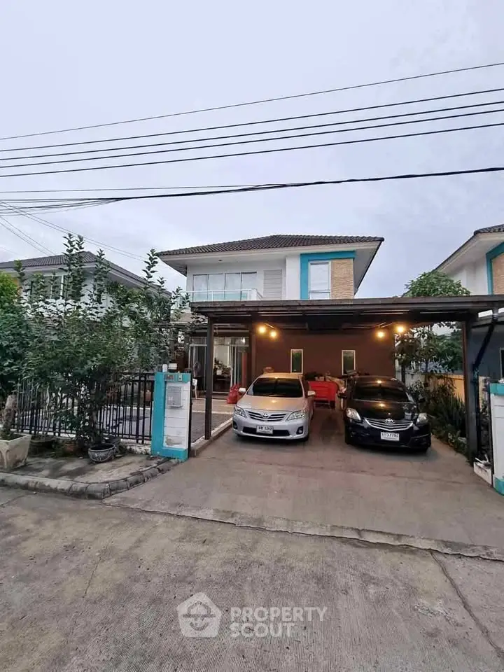 Charming two-story house with spacious driveway and carport, perfect for family living in a serene neighborhood.