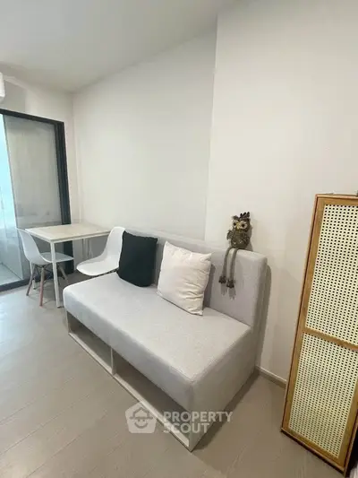 Modern living room with minimalist furniture and neutral tones, perfect for cozy urban living.